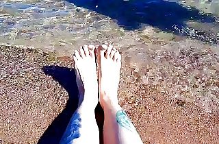 Mistress Nika enjoys the salty sea on her feet.